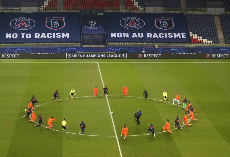 Referees, players protest racism by kneeling on pitch before PSG-Basaksehir football match in Paris