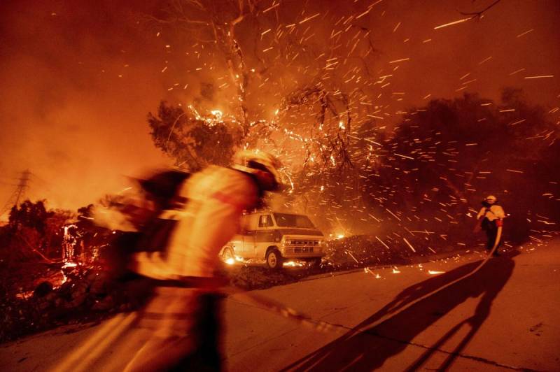 Wind fans wildfire in California canyons, residents flee