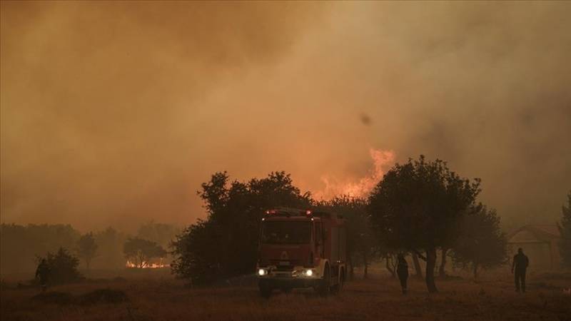 Several cars, homes damaged as wildfire rages on outskirts of Greek capital