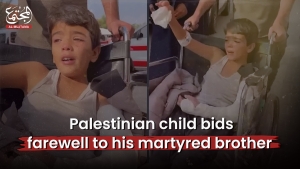 Palestinian child bids farewell to his martyred brother