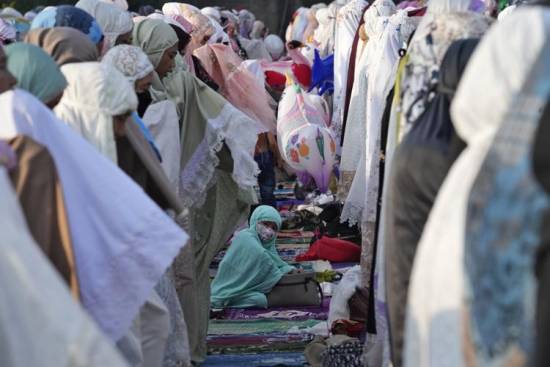 Muslims mark Eid al-Fitr holiday with joy, worry